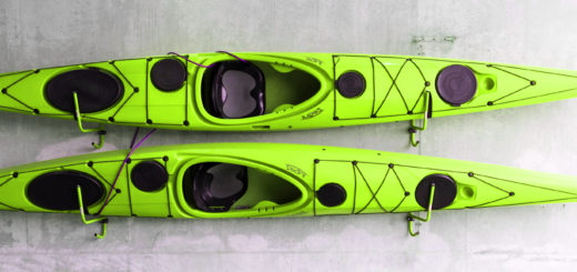 Green kayaks hanging on wall.